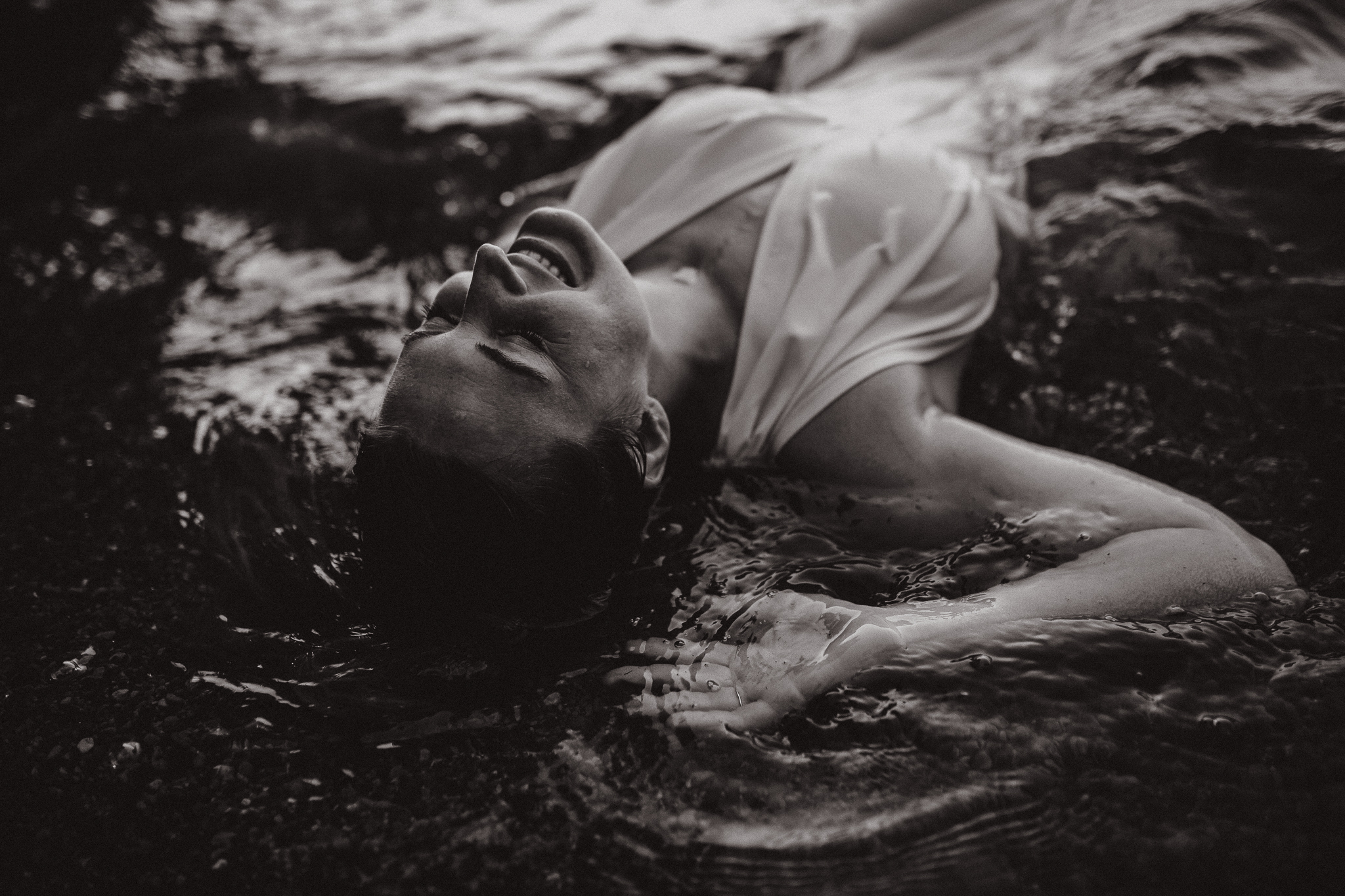 Captivating woman in an intimate lake session during a summer sunset.